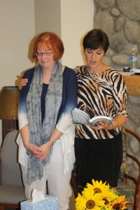 Henriet anoints Ardis' book and future speaking, September 2012.